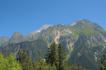 Fototapeta premium Alpine mountains with pine forest and granite tops in La Vanoise national park, France 