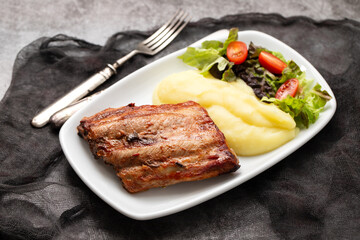 Braised ribs with potato puree and salad