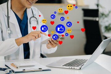 Male doctor using mobile phone play social media in office.