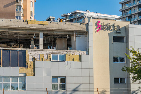 Under construction or renovation building with a blend of architectural styles, featuring large windows and a pink SADA sign on the facade The color palette is predominant - Kyiv, Ukraine 06-11-2024