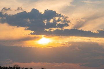 A tranquil sunset scene with the sun partially hidden, casting warm shadows and peacefulness