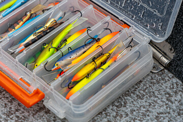 Fishing tackles and fishing baits in box .Classic Colored Fishing Lure , Beautiful Background...