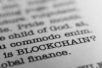 Blockchain technology. Text printed on a page. A piece of paper with a phrase written in retro...