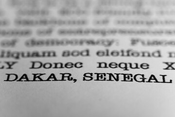 Obraz premium Dakar, Senegal. Text printed on a page. A piece of paper with a phrase written in retro typewriter font. Africa
