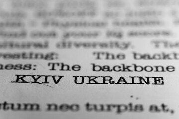 Fototapeta premium Kyiv, Ukraine. Text printed on a page. A piece of paper with a phrase written in retro typewriter font. Capital city