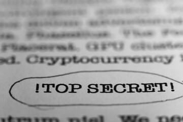 TOP SECRET. Text printed on a page. A piece of paper with a phrase written in retro typewriter font