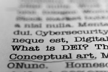 What is DEI. Text printed on a page. A piece of paper with a phrase written in retro typewriter font