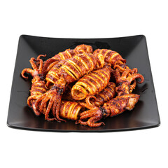 Grilled squid served on a black plate, showcasing vibrant colors and textures