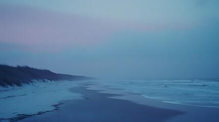 Naklejka premium Serene Beachscape at Dusk Tranquil Ocean Waves and Sandy Shore