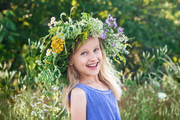 Summer Holiday on Nature. Happy Kid Little Girl with Flower Wreath on Landscape Background. Hello...