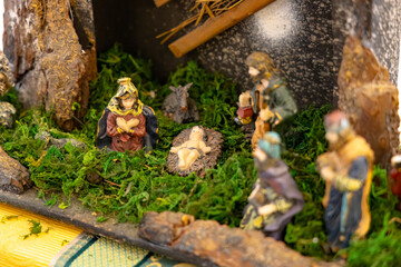 Small wooden nativity scene with baby Jesus, Mary, Joseph, and the three wise men, celebrating...