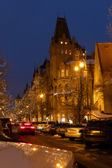 Fototapeta premium Paris street with christmas lights illuminating building at twilight