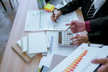 Male accountant using calculator and computer with pen on desk in office. Finance and accounting...