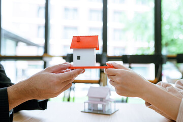 Asian businessman, real estate agent, discussing home purchase price, fees, mortgage, interest,...