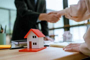 Asian businessman, real estate agent, discussing home purchase price, fees, mortgage, interest,...