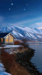 Fototapeta premium Wooden House on Shoreline Under Starry Sky with Snowy Mountains