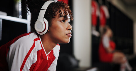 Thinking, soccer and woman with headphones in locker room for music, audio and radio for training....