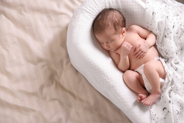 Bedtime. Cute little baby sleeping in lounger on bed indoors, top view