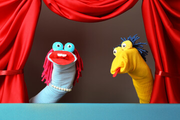 Creative puppet show on stage with red curtains