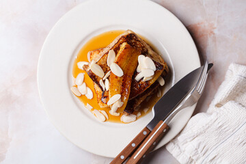 French toast with caramelized banana, syrup and almonds.