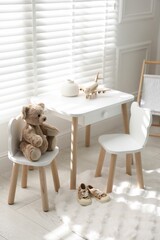 Different toys and stylish furniture in child's room