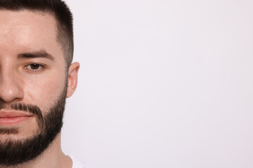 Fototapeta premium Man before shaving on light background, closeup. Space for text