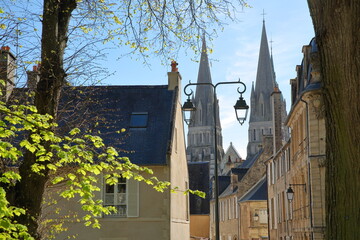 Historical houses and the spires of Notre Dame Cathedral viewed from Charles de Gaulle square in Bayeux, Calvados, Normandy, France 