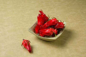 Fresh Rosella flowers in square bowl. Common name are Roselle hibiscus, Jamaican sorel, Hibiscus...