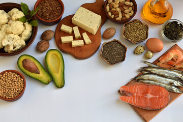Assorted ingredients rich in omega 3 on bright background including salmon, sardine, nuts, seeds,...