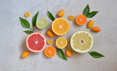 Citrus fruits including grapefruit, lemon, lime, orange and kumquat arranged creatively. Concept of...