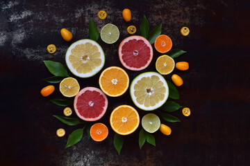Circular symmetrical layout of sliced citrus fruits including lemon, grapefruit, orange and...
