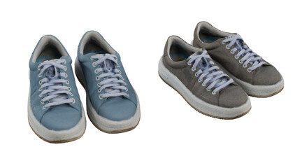Two pairs of used sneakers isolated on white
