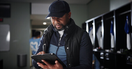 Tablet, coaching and black man with football strategy in locker room for game plan or defense formation. Touchdown tactics, sports and manager with technology, match feedback and training analysis
