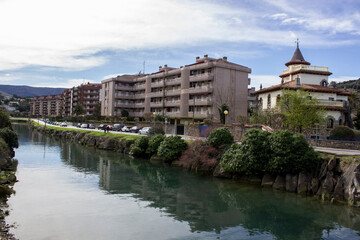 Fototapeta premium river canal along the road and houses; city landscape