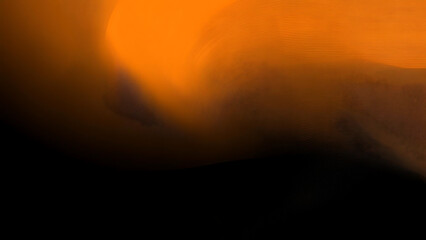 Fiery Abstract a captivating abstract image with intense orange and black hues, resembling a fiery inferno. The blurry, swirling form is reminiscent of a dynamic and energetic force.