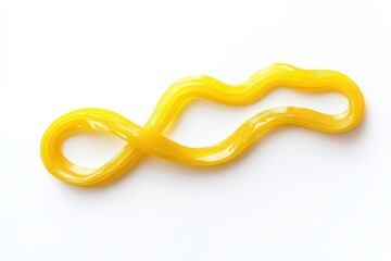 Naklejka premium Yellow, glossy, viscous substance in a flowing, looped pattern on a white background