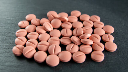 Tabletts or pills on the black background with space for text.