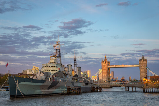 HMS Belfast moored on the River Thames with Tower Bridge in the background &mdash; a striking blend of naval history and iconic London architecture.