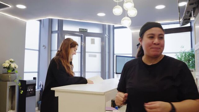 Dentist greeting patient at reception desk in dental clinic