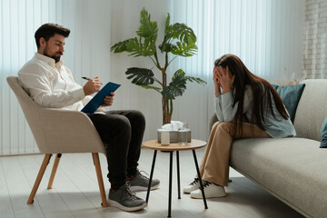 Older adult woman gets mental care treatment, woman visits psychotherapist, sitting on the sofa...