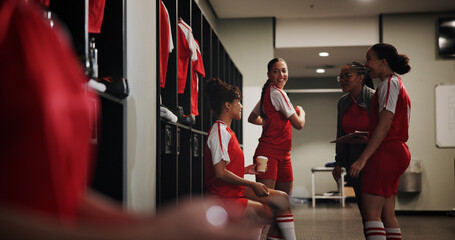 Sport, soccer and women in locker room with coach, preparation for match or break with talking and...