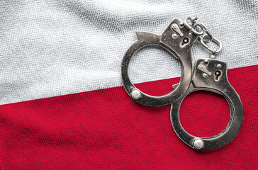 Flag of Polandand police handcuffs. Crime and offenses in country Concept
