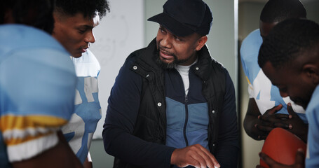 Meeting, coaching and football with team in locker room for game plan, sports strategy or defense...