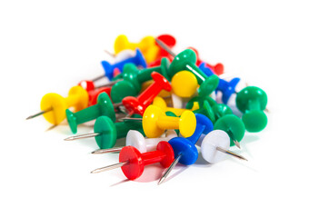 Several multi-colored thumbtack pins isolated on white background