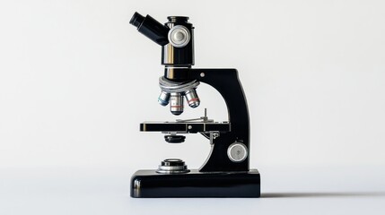 Classic black microscope on a plain background.