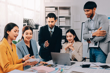 Team of financial advisory services. Asian advisor showing plan of investment to clients in the consultancy office..