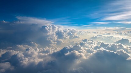 Fototapeta premium Wonderful view from the airplane window flying above the clouds cumulus clouds with blue sky in sunny day and soft sunlight in the afternoon nature background, creative banner, copyspace image