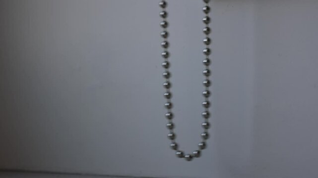 ball chain swinging, chain for curtain roller blinds swinging