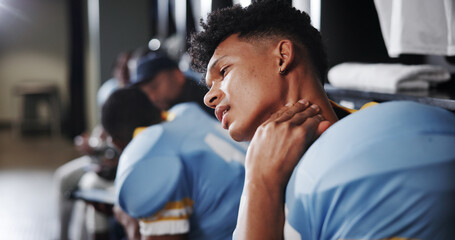 Man, American football player and neck pain with stress in locker room, frustrated or sprain with sport injury. Person, muscle ache and athlete with strain, bruise or massage for inflammation at club © EinFrame25/peopleimages.com