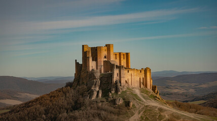 Obraz premium Beautiful Italian Castle on a Hilltop Under a Blue Sky in Italy